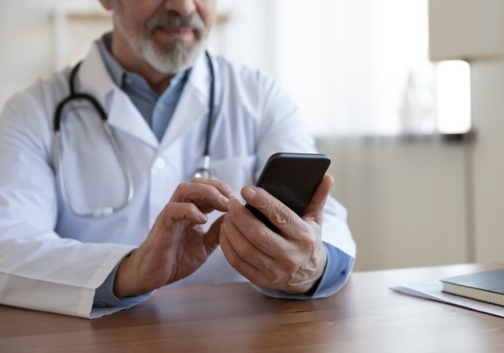 senior-male-doctor-using-mobile-phone-technology-apps-at-desk-picture-id1224799398-Jul-18-2024-10-45-06-5938-AM