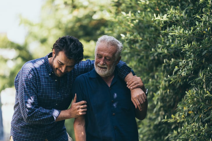 The-old-man-and-his-son-are-walking-in-the-park.-A-man-hugs-his-elderly-father.-They-are-happy-and-smiling-1214759397_2123x1417