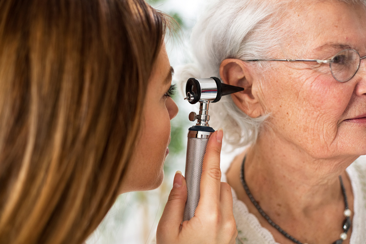 Doctor-looks-in-otoscope-to-examine-woman-ear